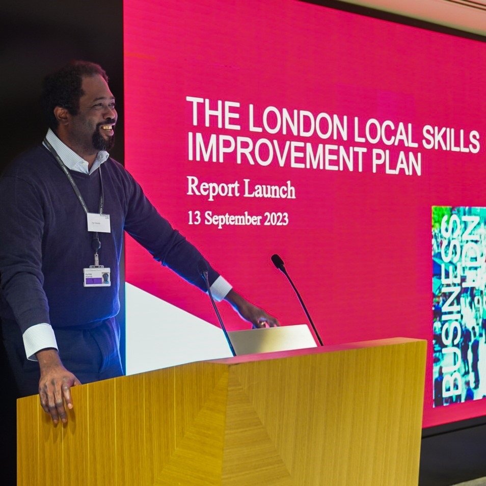 Ayo Akande at a lectern during a report launch